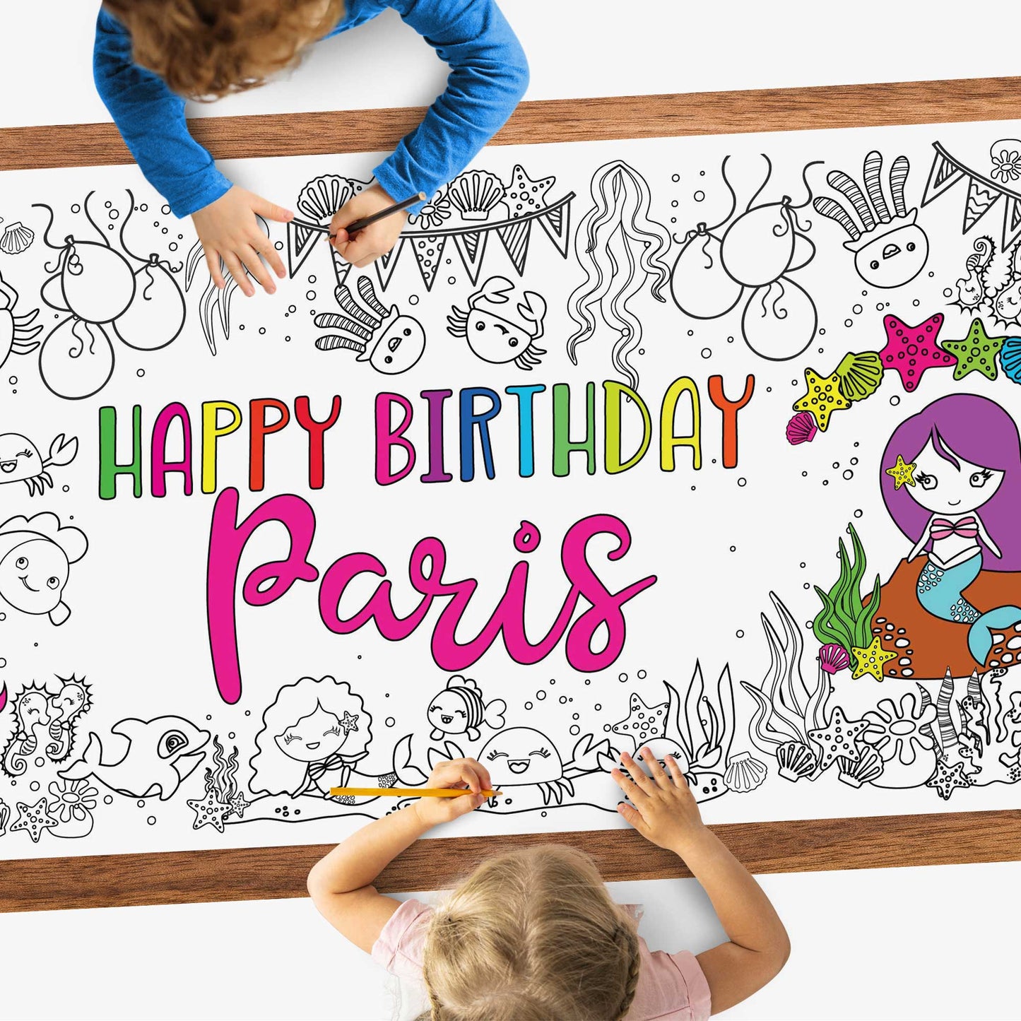 kids coloring a poster on a table