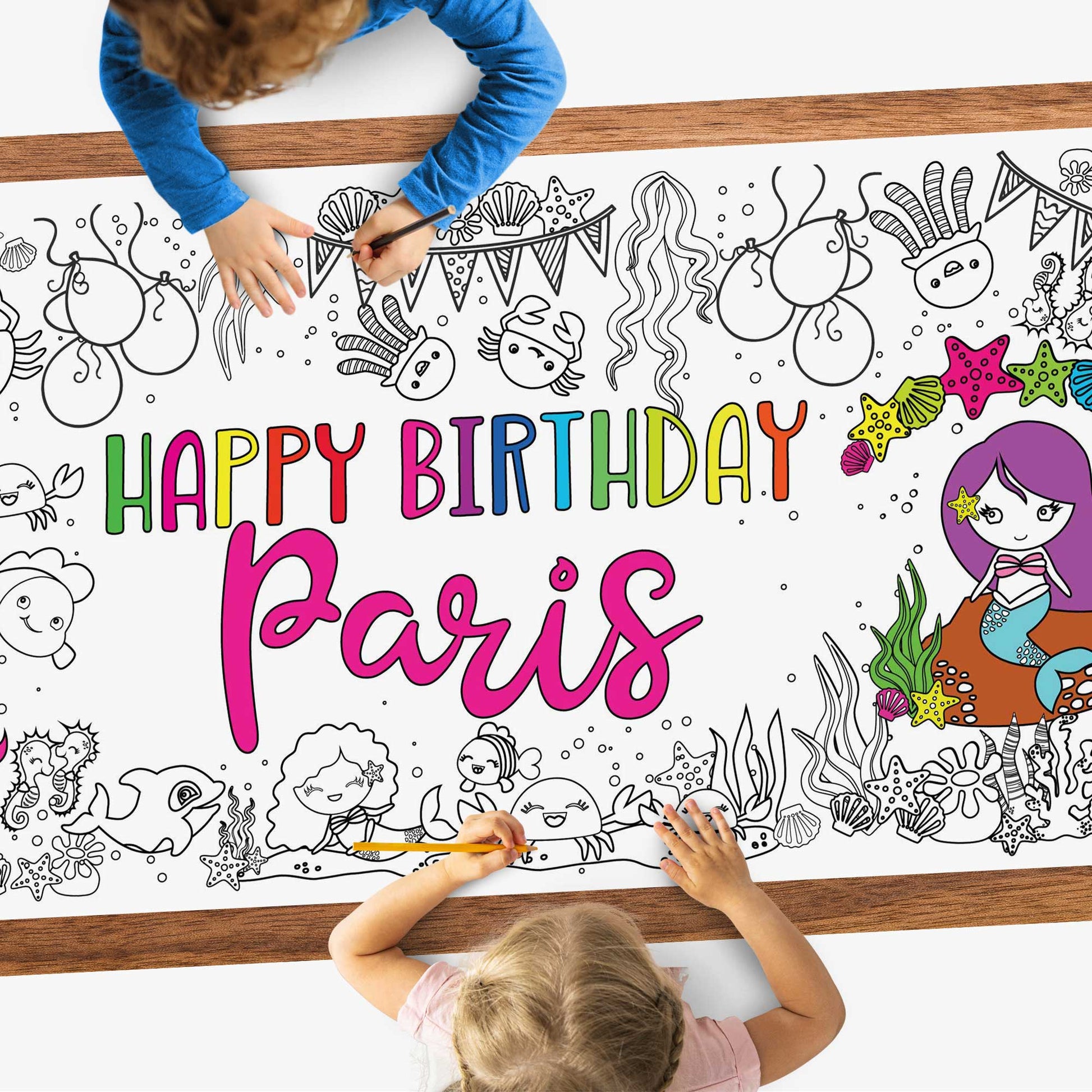 kids coloring a poster on a table